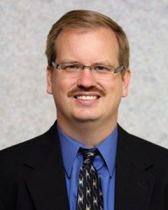 Dr. John McEachern wearing suit - headshot