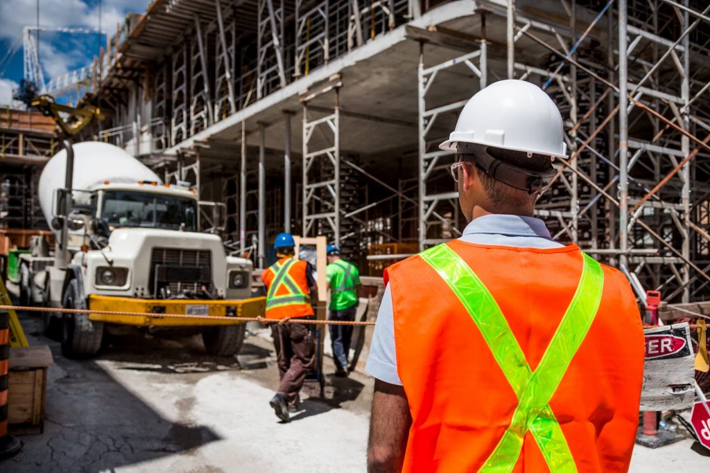 construction crew with backs to camera to show occupational medicine stock image