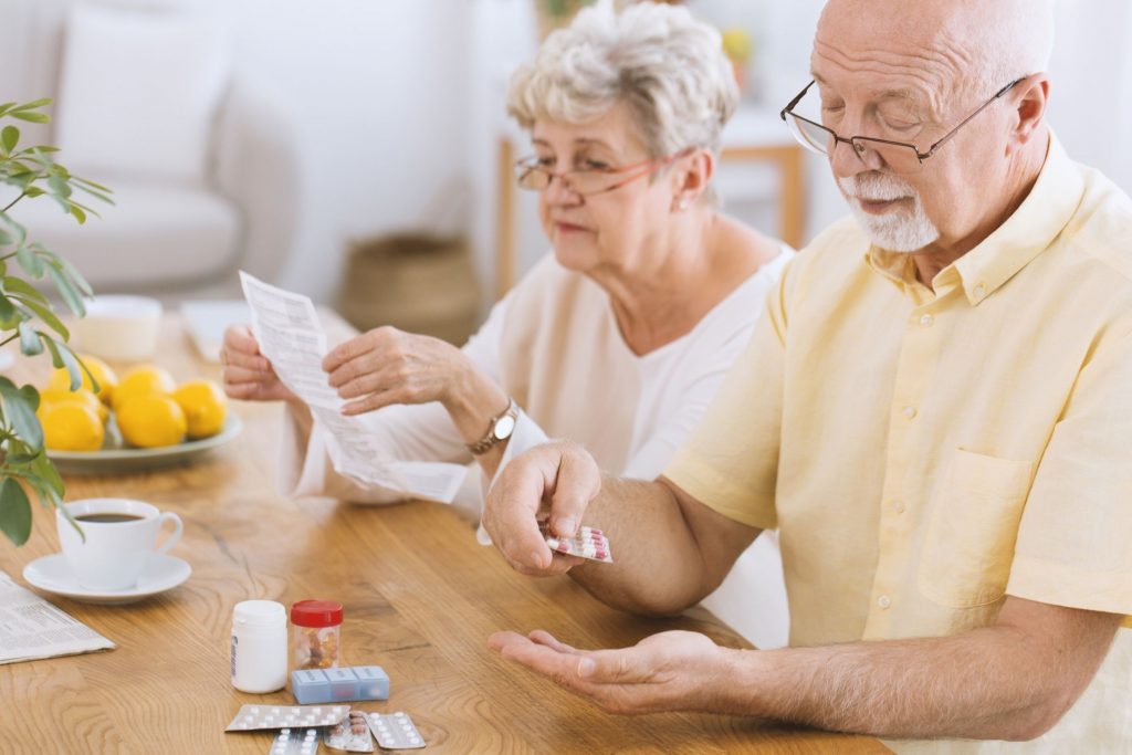 elderly white couple dividing up medicine for diabetes management