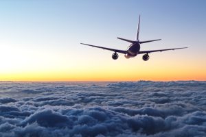 an airplane flying above the clouds