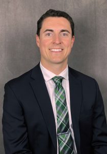 a man in a suit and tie smiling