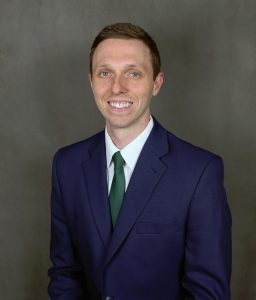 a man in a suit and tie smiling