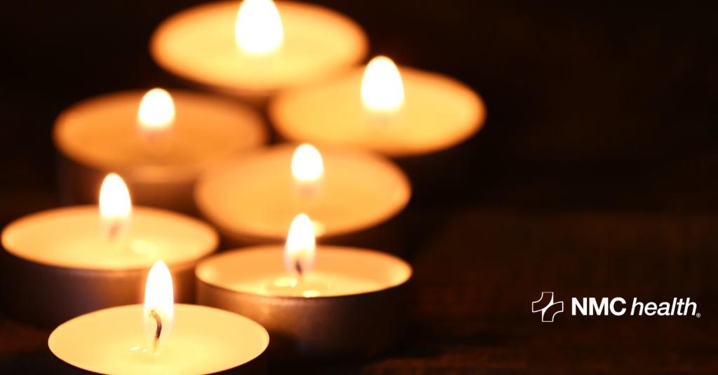 burning grief candles against dark background