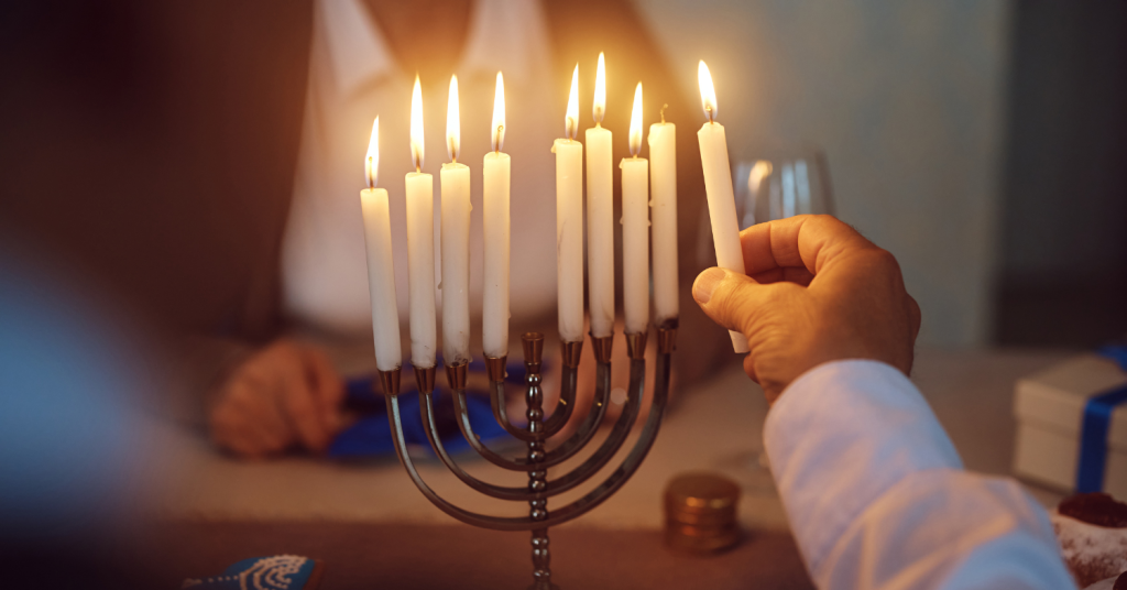 lighting the menorah candles for hanukkah