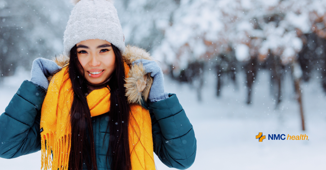 young woman wearing winter clothes in the snow