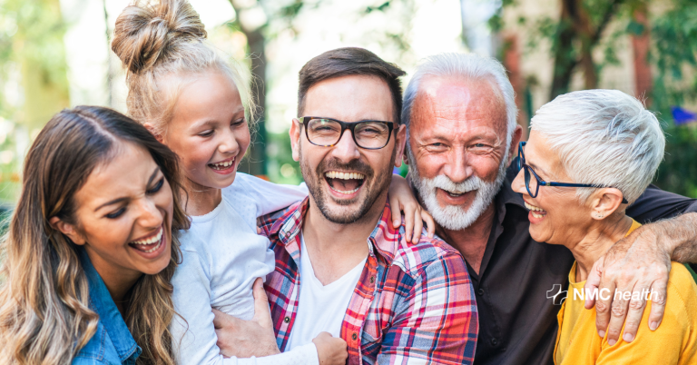 smiling happy intergenerational family outside on a sunny day